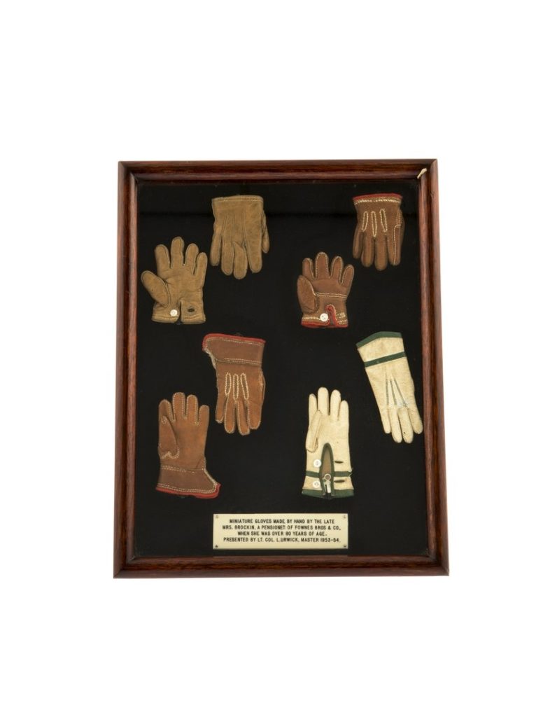 Presentation frame or box of four pairs of miniature gloves made by Mrs S Brockin
