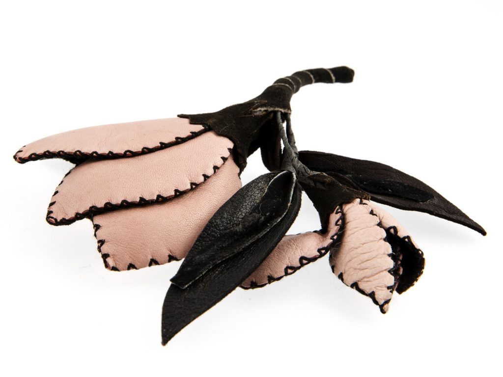 Woman's corsage  in pink leather and black suede leather in a flower design